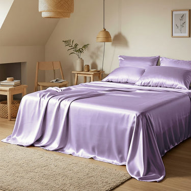 Purple satin bedding set on a bed in a bedroom with wooden furniture and decor.