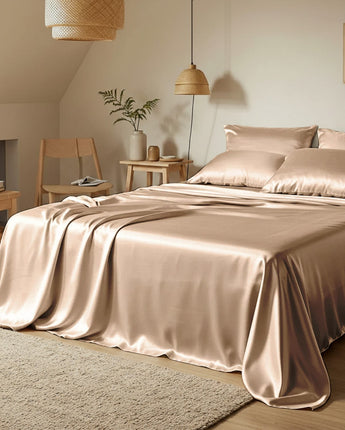 Bedroom with satin sheets and pillows in a cozy room setting.