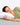 Woman sleeping on a pillow with Razzai logo in the corner
