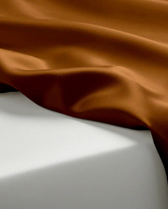 Brown fabric draped over a white surface