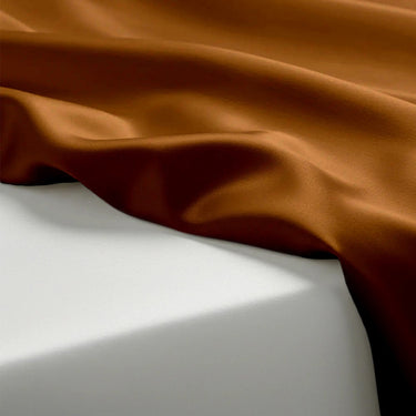 Brown fabric draped over a white surface