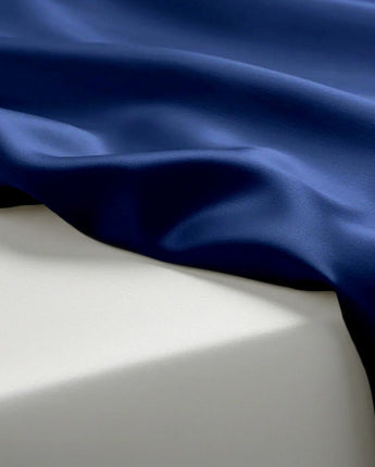 Close-up of blue fabric draped over a white surface
