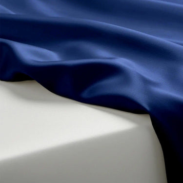 Close-up of blue fabric draped over a white surface