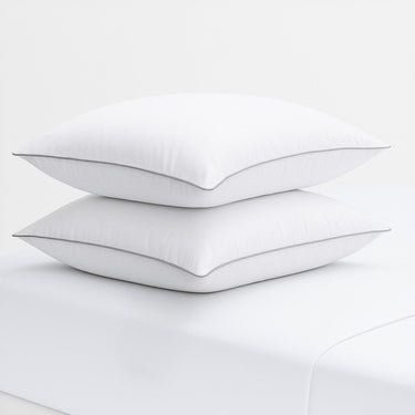 Two white pillows with a thin black line on a white background, featuring the Razzai brand logo.