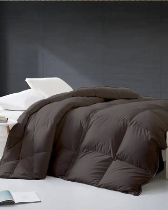 Brown comforter on a bed in a minimalistic bedroom setting